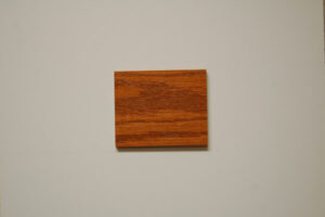 Sample of red oak wood with a dark natural stain showcasing the detailed grain and warm hue, ideal for the custom, high-quality cabinetry created by C&S Cabinets.
